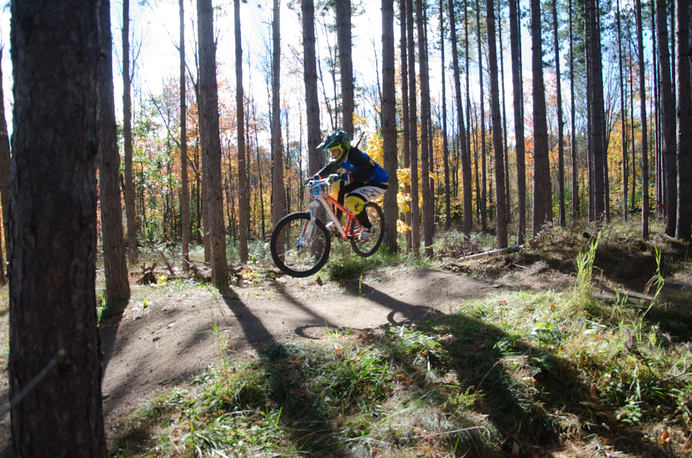 Dual slalom MTB racer airs over jump at the Michigan Tech Trails