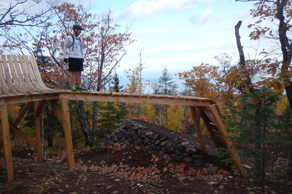 The wooden gap feature on the new Overflow downhill MTB trail at Copper Harbor